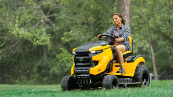 woman riding lawn mower